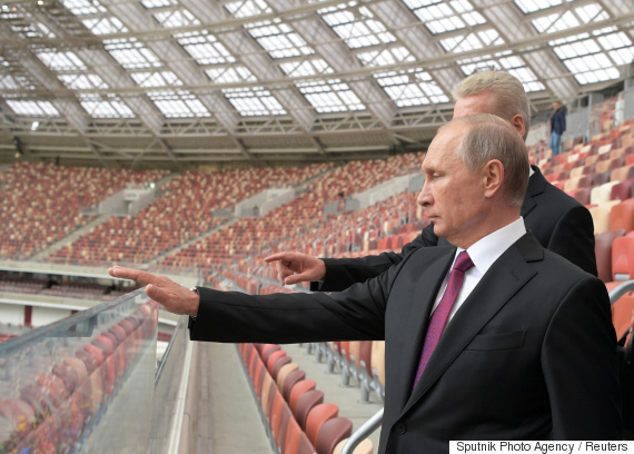Russian President Vladimir Putin listens to Moscow Mayor Sergei Sobyanin as they inspect the Luzhniki Stadium in Moscow